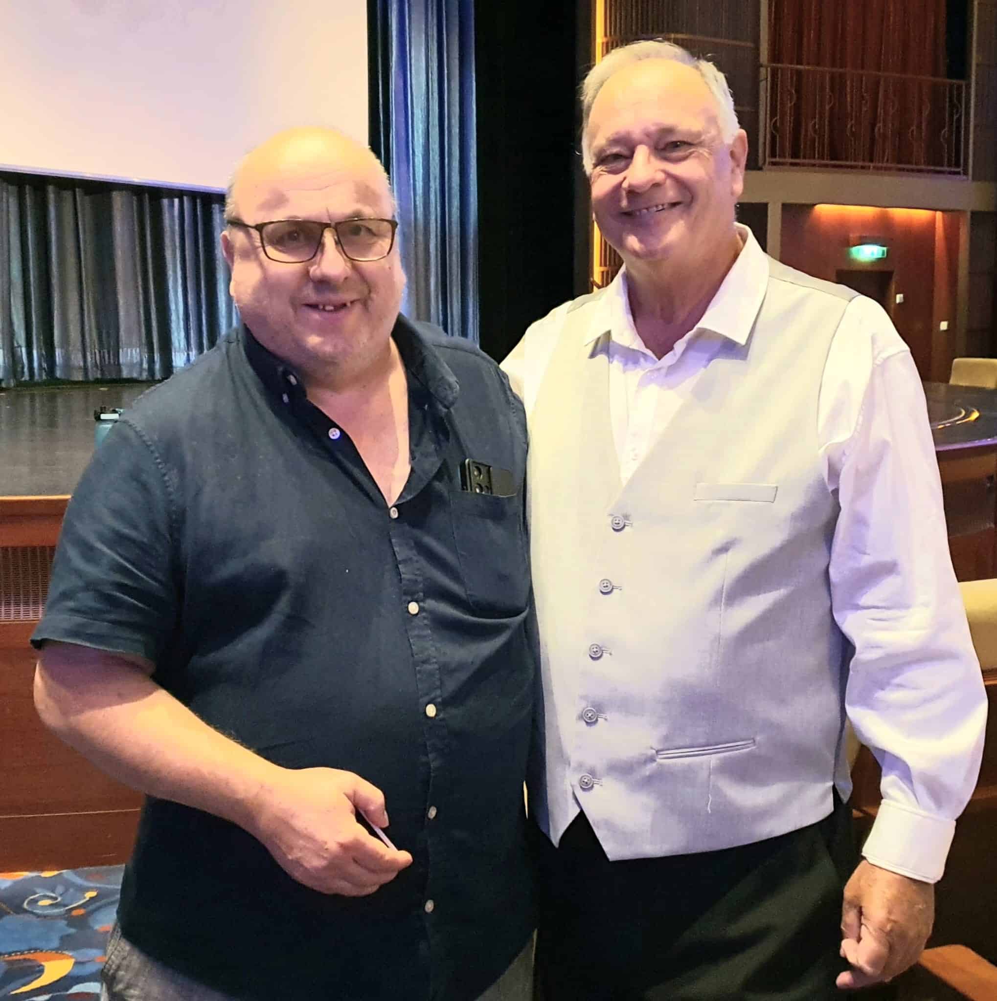 David Bunney at Welcome event, smiling with a guest in formal attire, in an elegant venue setting.